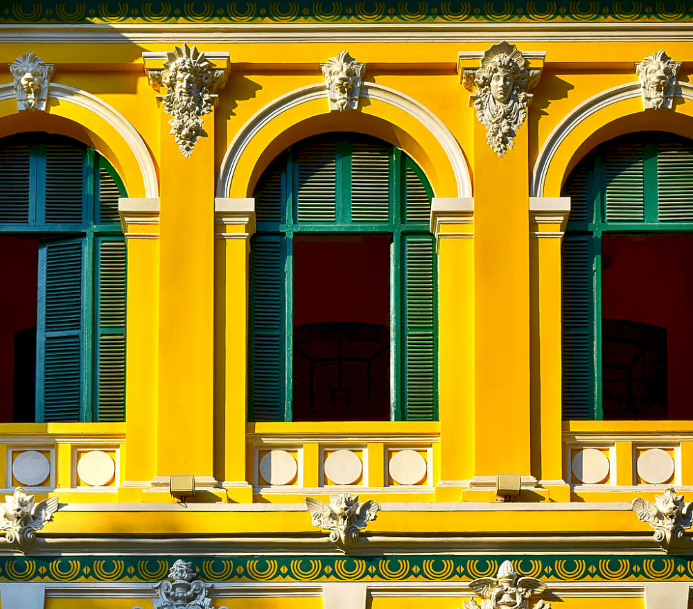 The blue windows, paired with the yellow paint, create an impressive contrast